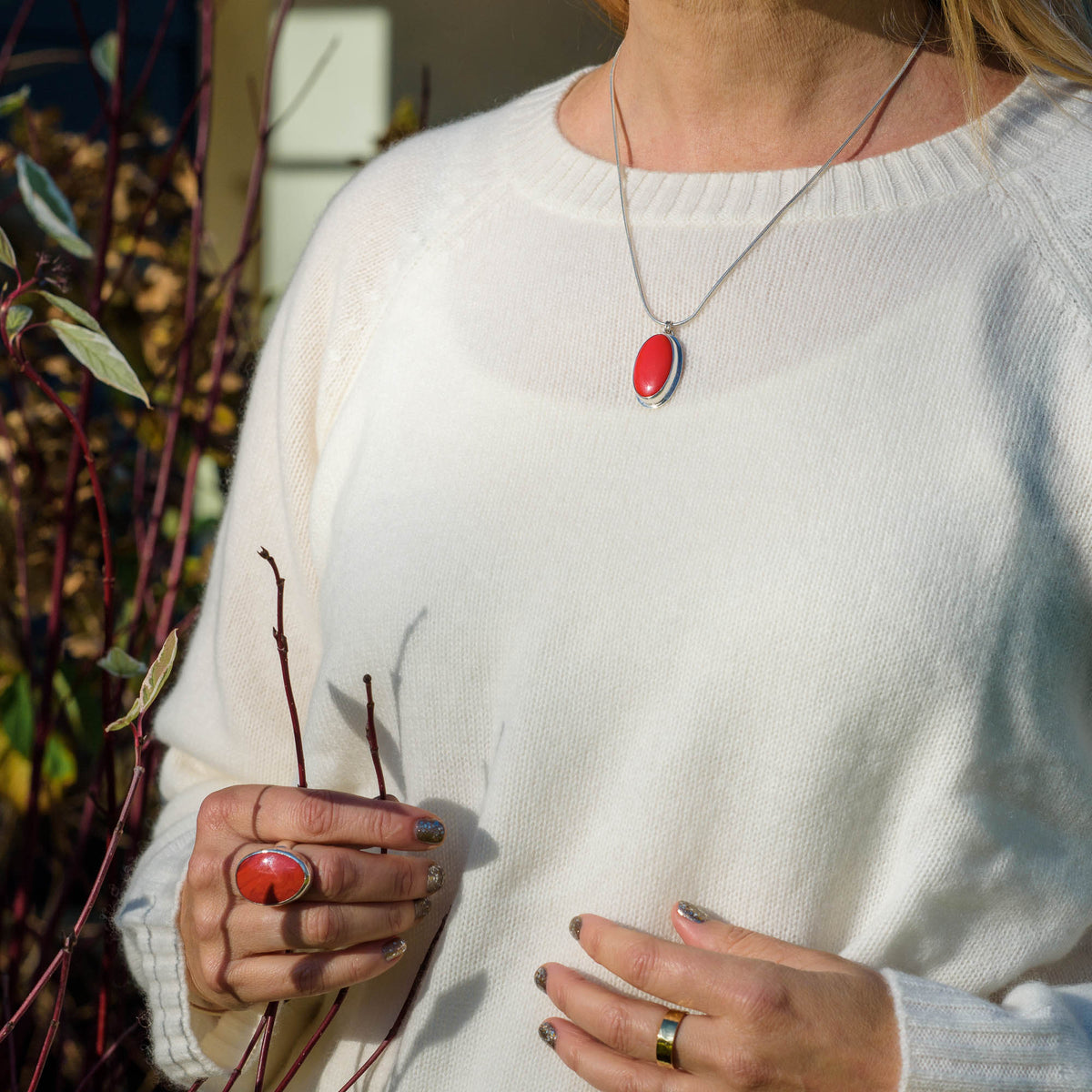 Woman wearing Red Rosarita and silver pendant and ring.  Handmade by Laura De Zordo Jewellery