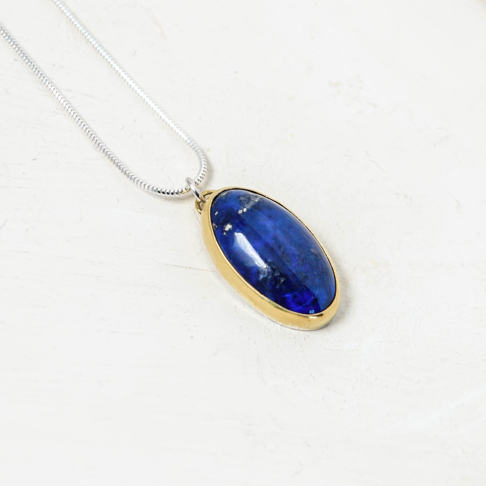 Lapis Lazuli Oval Pendant set in 22K gold with queen's jubilee hallmark.  Handmade by laura de zordo