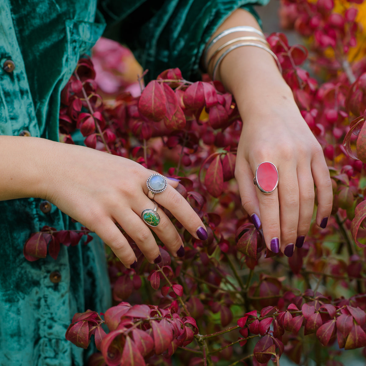 Large Red Rosarita and Silver ring handmade in the UK by Laura De Zordo.  Also showing moonstone ring and green turquoise rings and silver bangles