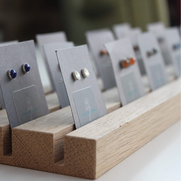 Row of 5mm earrings with various gemstones by Laura De Zordo Jewellery